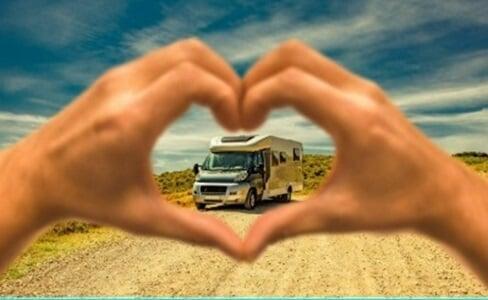 Hands forming a heart around a motorhome
