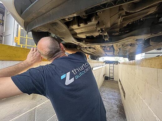 Technician inspecting a vehicle