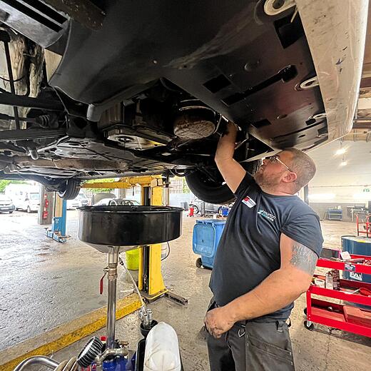 Technician working on a vehicle at Thurton Auto Centre